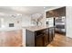 A kitchen with a large island, stainless steel appliances, hardwood floors and ample lighting at 1356 Castle Creek Cir, Castle Rock, CO 80104
