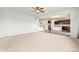 Open-concept living room with neutral carpet flooring leading to the kitchen and staircase at 1356 Castle Creek Cir, Castle Rock, CO 80104