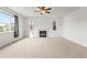Spacious living room with a fireplace, carpet flooring, and large window with neighborhood views at 1356 Castle Creek Cir, Castle Rock, CO 80104