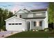 Charming two-story home featuring a two-car garage, a manicured lawn, and inviting curb appeal at 14155 Bunny Hop Ln, Parker, CO 80134