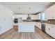 Modern, all white kitchen featuring an island, pendant lighting, and stainless steel appliances at 14155 Bunny Hop Ln, Parker, CO 80134