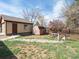 Backyard with a shed, garage, wooden fence, and small trees at 7669 Pecos St, Denver, CO 80221