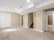 Spacious basement area with neutral carpeting, a staircase, and access to a bathroom, offering versatility at 7669 Pecos St, Denver, CO 80221