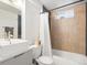Modern bathroom features square sink, tiled walls, and a tub/shower combo at 7669 Pecos St, Denver, CO 80221