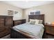 Comfortable bedroom with neutral colors, wood furnishings, and bright natural light at 7669 Pecos St, Denver, CO 80221