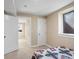 Cozy bedroom showcases natural light, doorway, closet, and bed with intricate geometric patterns on a quilt at 7669 Pecos St, Denver, CO 80221