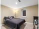 Bedroom featuring dark bed linens and a large window providing natural light, creating a comfortable retreat at 7669 Pecos St, Denver, CO 80221