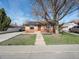Charming single-story home with a walkway and beautiful tree at 7669 Pecos St, Denver, CO 80221