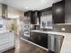 Updated kitchen featuring stainless steel appliances, stylish cabinets, and quartz countertops at 7669 Pecos St, Denver, CO 80221