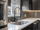 Close up of kitchen sink with stainless steel appliances and backsplash at 7669 Pecos St, Denver, CO 80221
