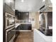 Modern kitchen with stainless steel appliances, dark wood cabinets, and hardwood floors at 7669 Pecos St, Denver, CO 80221