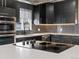 Contemporary kitchen featuring stainless steel appliances, dark cabinets, and modern cooktop at 7669 Pecos St, Denver, CO 80221