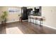 Spacious living room area with hardwood floors and view into the kitchen and dining area at 7669 Pecos St, Denver, CO 80221