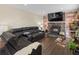 Spacious living room with a stone fireplace, large TV, hardwood floors, and comfortable seating at 7669 Pecos St, Denver, CO 80221