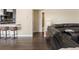 A glimpse of a modern living room with hardwood floors and comfortable seating, leading to the kitchen at 7669 Pecos St, Denver, CO 80221