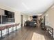 Open concept living space with bar seating and view of the cozy living room with fireplace at 7669 Pecos St, Denver, CO 80221