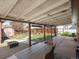 Covered patio includes table, chairs and view of shed and backyard at 7669 Pecos St, Denver, CO 80221