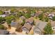 An aerial view showcases a cozy residential neighborhood with lush trees, colorful homes, and ample parking spaces at 2924 Fulton St, Denver, CO 80238