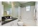 Bright bathroom with granite countertop, white cabinets, and shower/tub combo at 2924 Fulton St, Denver, CO 80238
