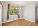 Bright dining room with hardwood floors, a stylish chandelier, and a large window offering a pleasant view of the outdoors at 2924 Fulton St, Denver, CO 80238