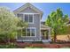 Charming two-story home with gray siding, white trim, a covered porch, and a well-manicured front yard with a picket fence at 2924 Fulton St, Denver, CO 80238