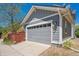 Attached garage with gray door and siding at 2924 Fulton St, Denver, CO 80238