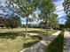 Community green space with trees, sidewalks, and neighborhood houses at 2924 Fulton St, Denver, CO 80238