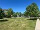Expansive green space surrounded by mature trees and well-maintained lawns at 2924 Fulton St, Denver, CO 80238
