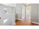 Upstairs hallway with hardwood floors, natural light, and closet at 2924 Fulton St, Denver, CO 80238