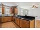 Spacious kitchen with wood cabinets, granite countertops, stainless steel appliances, and hardwood floors at 2924 Fulton St, Denver, CO 80238