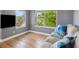 Cozy living room nook featuring hardwood floors, bright window views and a comfortable sofa at 2924 Fulton St, Denver, CO 80238