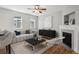 Cozy living room featuring a plush sofa, fireplace, and hardwood flooring at 2924 Fulton St, Denver, CO 80238