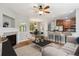 Open-concept living room with a fireplace, modern furnishings, and hardwood floors at 2924 Fulton St, Denver, CO 80238