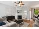 Inviting living room with fireplace, hardwood floors, and an open floor plan at 2924 Fulton St, Denver, CO 80238