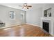Spacious living room with hardwood floors, a decorative fireplace, and natural light from large windows, creating a cozy space at 2924 Fulton St, Denver, CO 80238