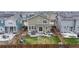 Aerial view showcasing the backyard with a patio, lawn, play area, and the home's exterior at 13144 E 109Th Pl, Commerce City, CO 80022