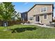 Large backyard featuring green grass, a playset and paver patio at 13144 E 109Th Pl, Commerce City, CO 80022