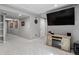 Finished basement with gray carpet, entertainment center and mounted TV at 13144 E 109Th Pl, Commerce City, CO 80022