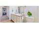 Bathroom featuring double sinks, white cabinets, and tile floors at 13144 E 109Th Pl, Commerce City, CO 80022