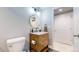 Bathroom boasts modern vanity, fixtures, and round mirror, blending style with functionality at 13144 E 109Th Pl, Commerce City, CO 80022