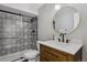 Bathroom features a tiled shower/bath and modern wood vanity with granite countertop at 13144 E 109Th Pl, Commerce City, CO 80022