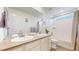 Bright bathroom with double sinks, modern fixtures, and a shower-tub combo at 13144 E 109Th Pl, Commerce City, CO 80022