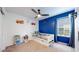A bedroom with a blue accent wall, decor, and plenty of natural light at 13144 E 109Th Pl, Commerce City, CO 80022