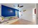 Bedroom featuring blue accent wall, ceiling fan, and carpet floors at 13144 E 109Th Pl, Commerce City, CO 80022