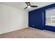 Bedroom with a modern ceiling fan, plush carpet and accent wall at 13144 E 109Th Pl, Commerce City, CO 80022