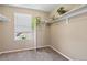 Neutral walk-in closet with built-in shelves and a sunlit window at 13144 E 109Th Pl, Commerce City, CO 80022