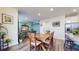 Bright dining area features a wooden table with chairs, open to the kitchen and a view into the living room at 13144 E 109Th Pl, Commerce City, CO 80022