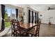 Open dining area with hardwood floors, sliding glass doors to the backyard, and stylish decor at 13144 E 109Th Pl, Commerce City, CO 80022