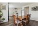 Elegant dining area featuring hardwood floors, a ceiling fan, and seamless access to the living area at 13144 E 109Th Pl, Commerce City, CO 80022