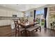 Bright dining area with a large wooden table, bench seating, and easy access to the backyard at 13144 E 109Th Pl, Commerce City, CO 80022